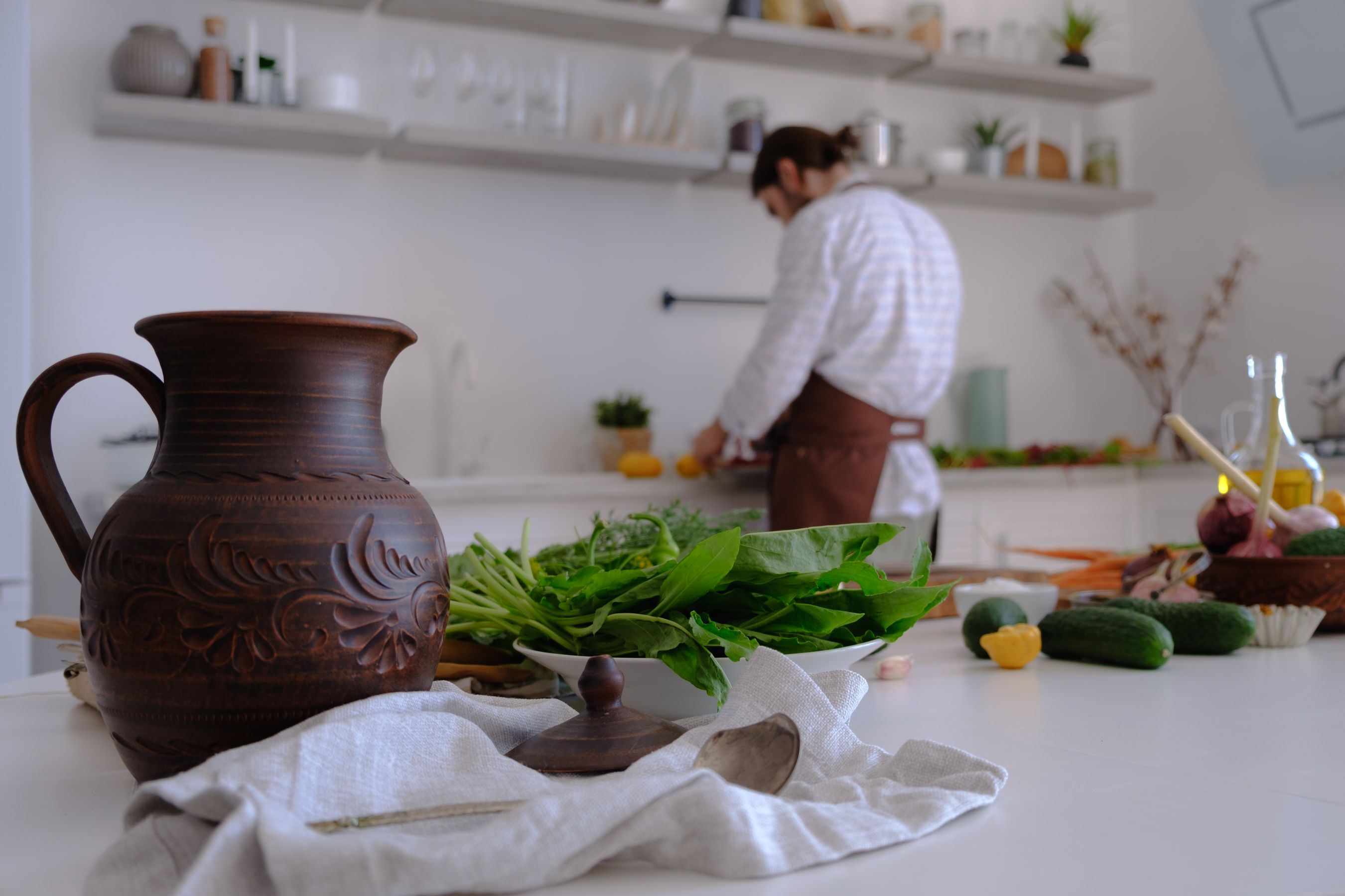 A bright rustic kitchen with fresh ingredients on a wooden table.